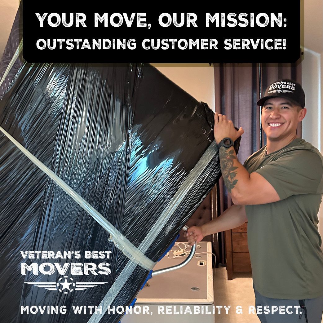 A man is holding a large piece of furniture wrapped in plastic.